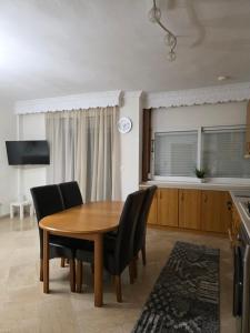 a dining room with a wooden table and chairs at Searea House in Perea