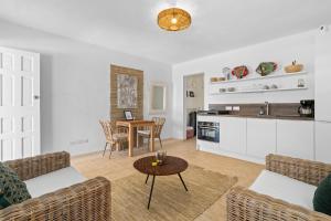 a living room with a table and a kitchen at Maravia Bonaire in Kralendijk +30 photos