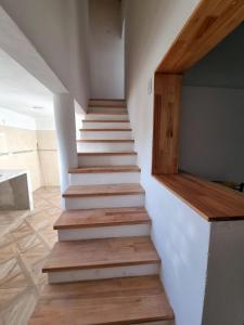 a staircase in a house with wooden floors at El Solar in San Antonio Oeste