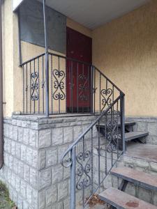 a staircase with a red door on a building at Квартира Шевченка in Lutsk