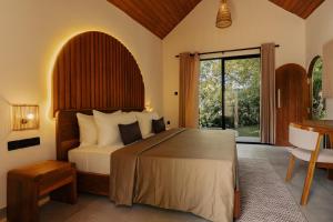 a bedroom with a large bed and a desk at The Benison in Ahangama +74 photos
