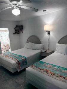 a bedroom with two beds and a ceiling fan at Apollo Motel in Wildwood Crest +62 photos