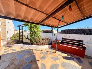 a bench under awning on a patio at myplace in Tiagua