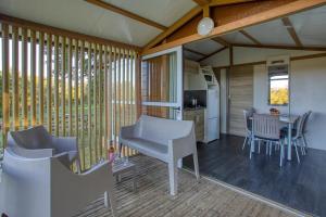 a kitchen and dining area of a tiny house at ZEcamping 3 étoiles familial do friendly piscine chauffée restaurant et bar in Les Eyzies-de-Tayac