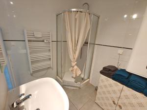 a bathroom with a shower and a toilet and a sink at Le studio Mauperthuis in Forges