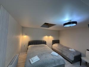 a bedroom with two beds and a blue ceiling at Hotel Kalyan & Spa in Chişinău +129 photos