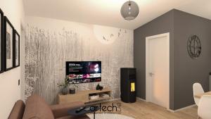 een woonkamer met een tv aan de muur bij Casa Reiner in Bondone