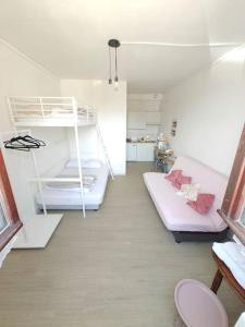 a room with a bunk bed and a couch at Le studio Mauperthuis in Forges
