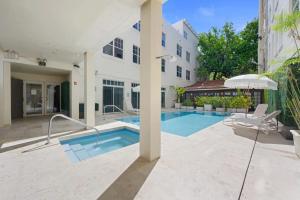 a swimming pool in front of a building at Bellio in Sobe in Miami Beach