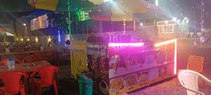 a food stand with umbrellas and a table and chairs at Shiv Shakti Hotel And Resort in Mākundgarh