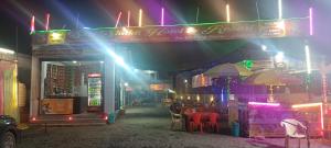 a store with chairs and umbrellas at night at Shiv Shakti Hotel And Resort in Mākundgarh
