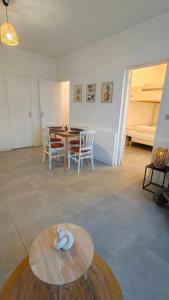 a living room with a table and a dining room at L'Orangerie du Domaine F3 in Forges +7 photos