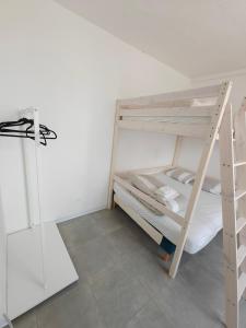 a bedroom with a bunk bed and a ladder at L'Orangerie du Domaine F3 in Forges