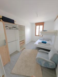 a bedroom with two bunk beds and a couch at Le Grand Mauperthuis F4 in Forges