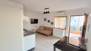 a kitchen and a living room with a couch at Olcsica Apartment in Klenovica +21 photos