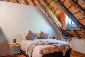 a bedroom with a bed and a large window at The ChaBo Lodge in Marloth Park