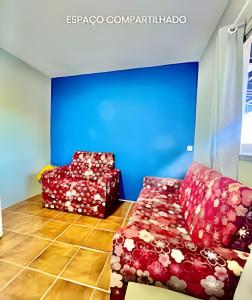 two chairs and a couch in a room at Thebluee Matinhos beach in Matinhos +13 photos