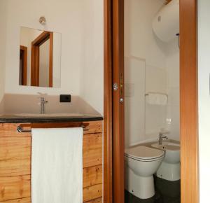 a bathroom with a toilet and a sink at Ca Poschiavini - Casa Lares in Casa Piali +38 photos