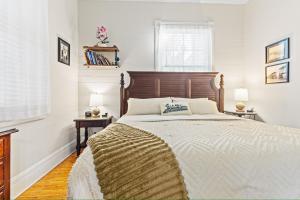 a bedroom with a large bed with a wooden headboard at The Island Suite at KW Vacation in Key West