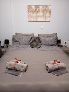 a bedroom with a bed with towels on it at Ηome & Garden with parking close to Olympic Stadium in Athens