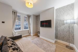 a living room with a bed and a window at 12 osbourne road in Gillingham