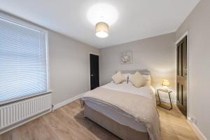 a bedroom with a bed and a window at 12 osbourne road in Gillingham