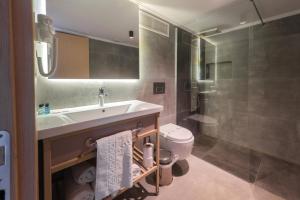 a bathroom with a sink and a toilet and a shower at Perast Garden Hotel in Cıralı +80 photos