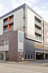 a building with a sign on the side of it at CozySuites at 747 Apts in Indianapolis