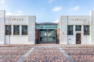 a building with the entrance to the garage at CozySuites at 747 Apts in Indianapolis +36 photos