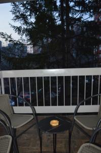 a bench with a table and chairs on a balcony at Gohemi Apartments in Pirot