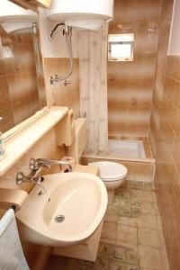 a bathroom with a sink and a toilet at Apartments Mat in Vis