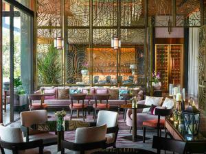 ein Restaurant mit Tischen und Stühlen und eine Lobby in der Unterkunft V Villas Phuket - MGallery Collection in Panwa Beach