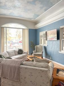 a living room with two couches and a window at 1 Min to Hospitals Spacious 4 Bed Stay in Billings