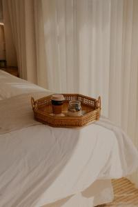 a tray with a drink and a cup on a bed at Hillcrest Merimbula in Merimbula