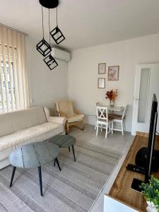 a living room with a couch and a table at Apartment DUNJA Laktasi in Laktaši