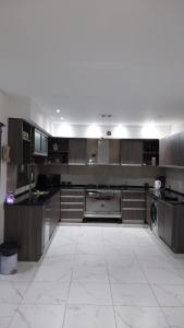 a large kitchen with a large white tile floor at CASA CON PILETA EN EL CENTRO de CORRIENTES in Corrientes