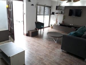 a living room with a couch and a table at CASA CON PILETA EN EL CENTRO de CORRIENTES in Corrientes