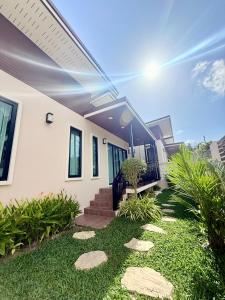 a house with a pathway in front of it at PS House Bangtao in Bang Tao Beach