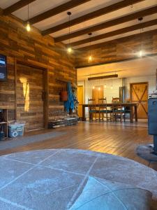 a large room with a wooden floor and a table at Hostal Celta in Pucón