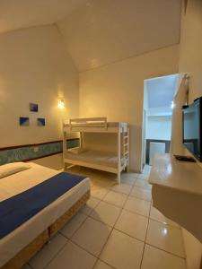 En eller flere senge i et værelse på Pousada Chalés Jardim das Aguas + 9 billeder