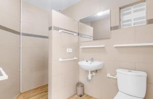 a white bathroom with a toilet and a sink at Something Els in Willemstad +27 photos