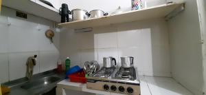 a small kitchen with a stove and a sink at casa n 3 jeri in Jericoacoara