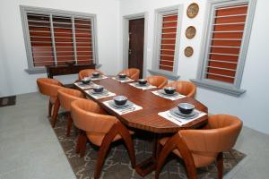 a wooden table and chairs in a room at Sikeci Villa in Pacific Harbour +22 photos