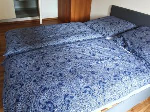 a bed with a blue blanket on top of it at Poolside Apartment in Italian Villa in San Lorenzo al Mare +20 photos