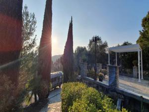 a view of a train station with two trees at Poolside Apartment in Italian Villa in San Lorenzo al Mare