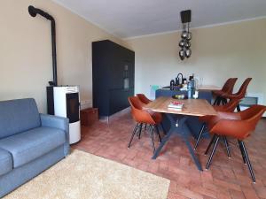 a living room with a table and chairs and a couch at Poolside Apartment in Italian Villa in San Lorenzo al Mare