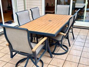 a wooden table with four chairs around it at Futtsu Pool Villa A&F -富津プールヴィラ A&F- in Futtsu