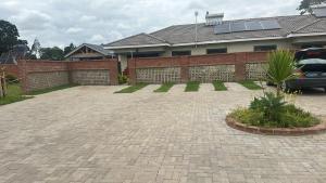 a brick parking lot in front of a house at Hatfield Staylax Manor 4 in Harare