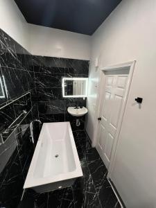 - une salle de bains en noir et blanc avec lavabo et toilettes dans l'établissement Elegant 1-Bedroom Retreat, à Miami