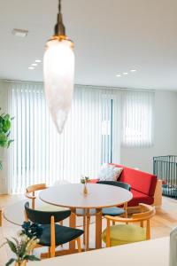 a living room with a table and chairs and a couch at 藤乃宿 ペットと暮らすように泊まる宿 in Sapporo